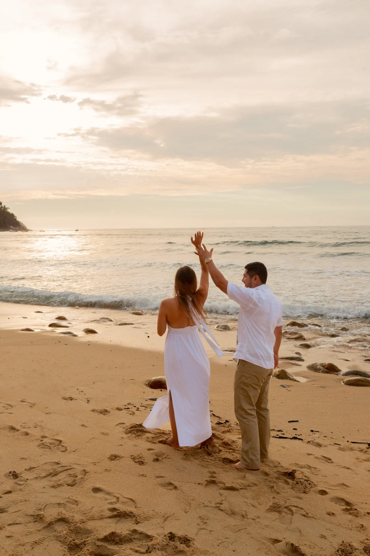 Couple celebrating their engagement at sunset on a Puerto Vallarta beach